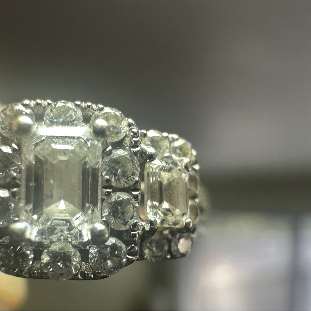 One lady’s 14 karat white gold 3-stone engagement ring.